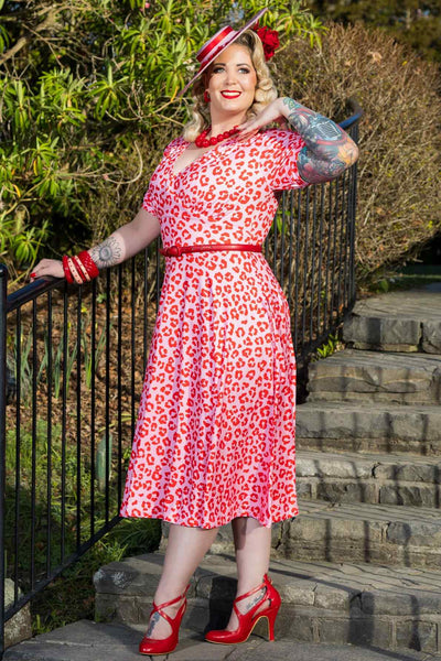 A lady wearing a Julia Pink Cheetah Print Midi Dress