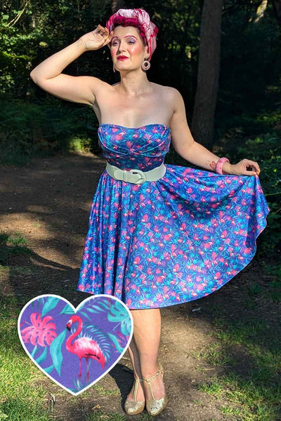 Front view of a model wearing our strapless swing dress in purple/pink flamingo print