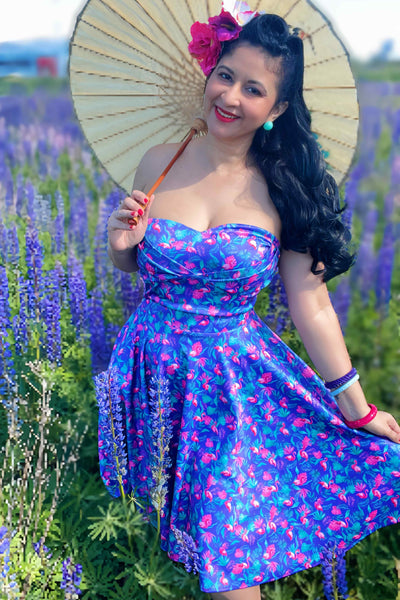 Front view of Pink Flamingo Strapless Dress in Purple flower field, with parasol