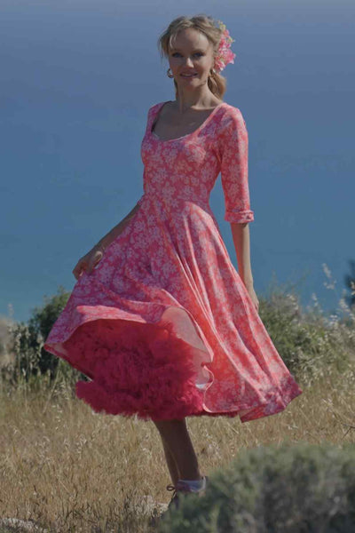 A lady wearing a Pink Floral Garden Circle Dress