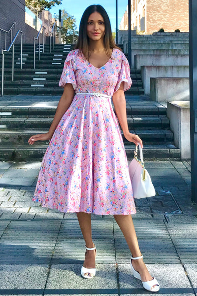 A lady wearing a Pink Floral Polka Dot Petal Sleeve Dress