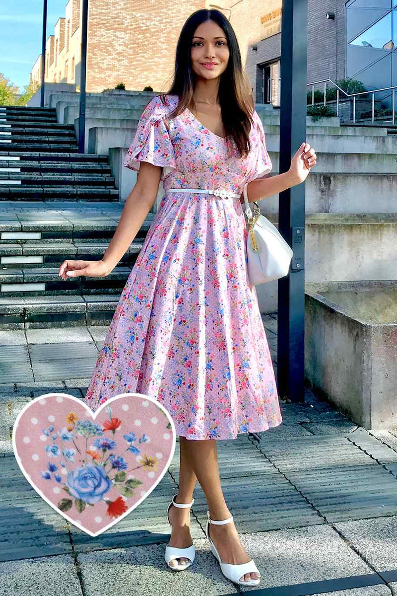 A lady wearing a Pink Floral Polka Dot Petal Sleeve Dress