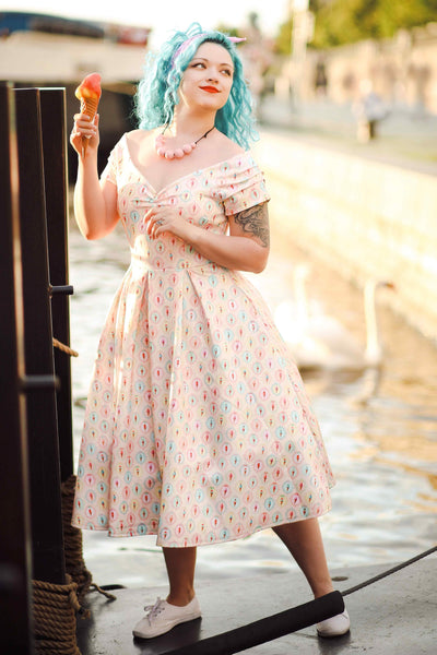 A girl wearing a Pink Gelato Off Shoulder Dress