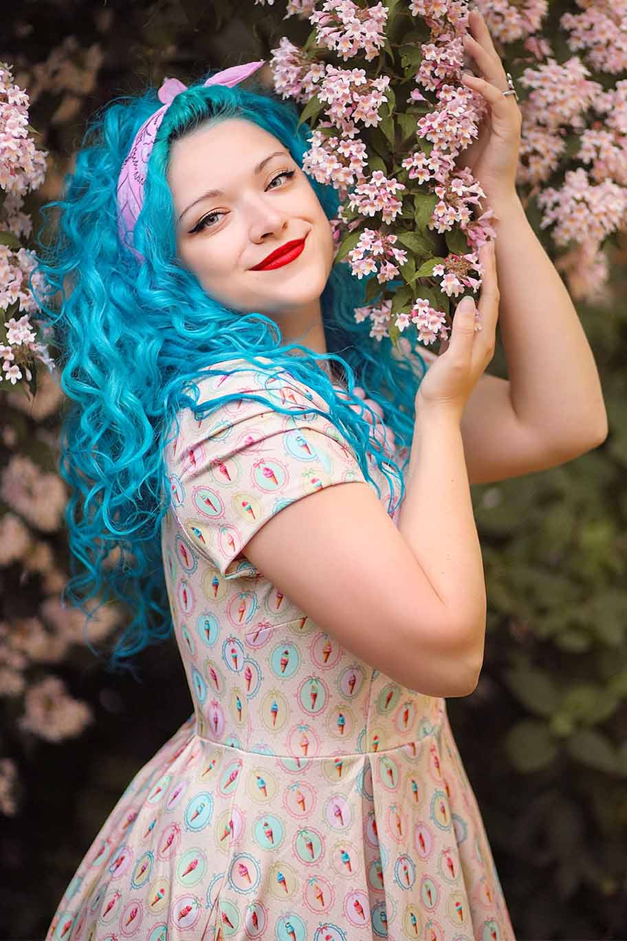 A model wearing a Pink Gelato Off Shoulder Dress