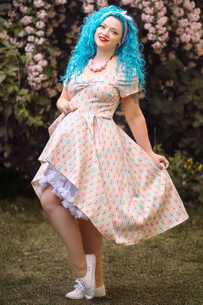 A photo of a girl wearing a Pink Gelato Off Shoulder Dress