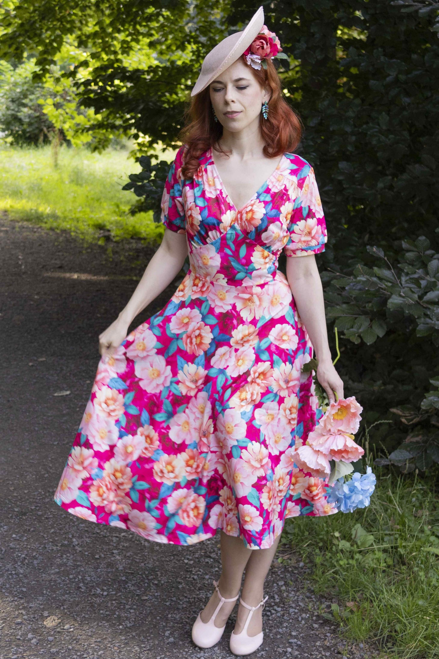 A lady in Julia Pink Magnolia Casual Midi Dress