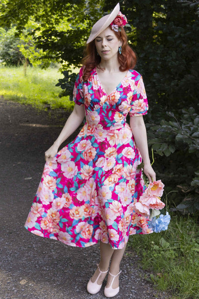 A lady in Julia Pink Magnolia Casual Midi Dress