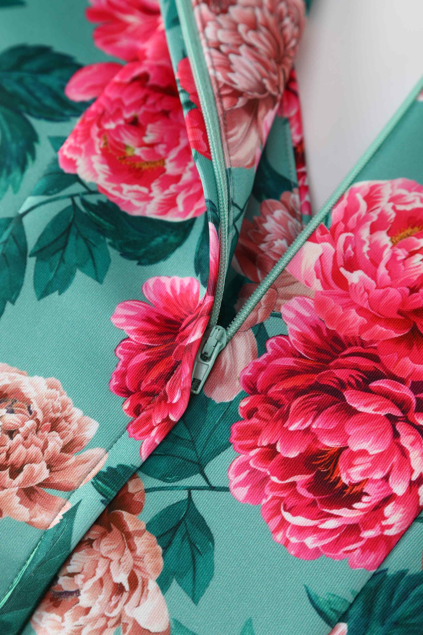 Close up view of Pink Peony Off Shoulder Dress In Mint Green