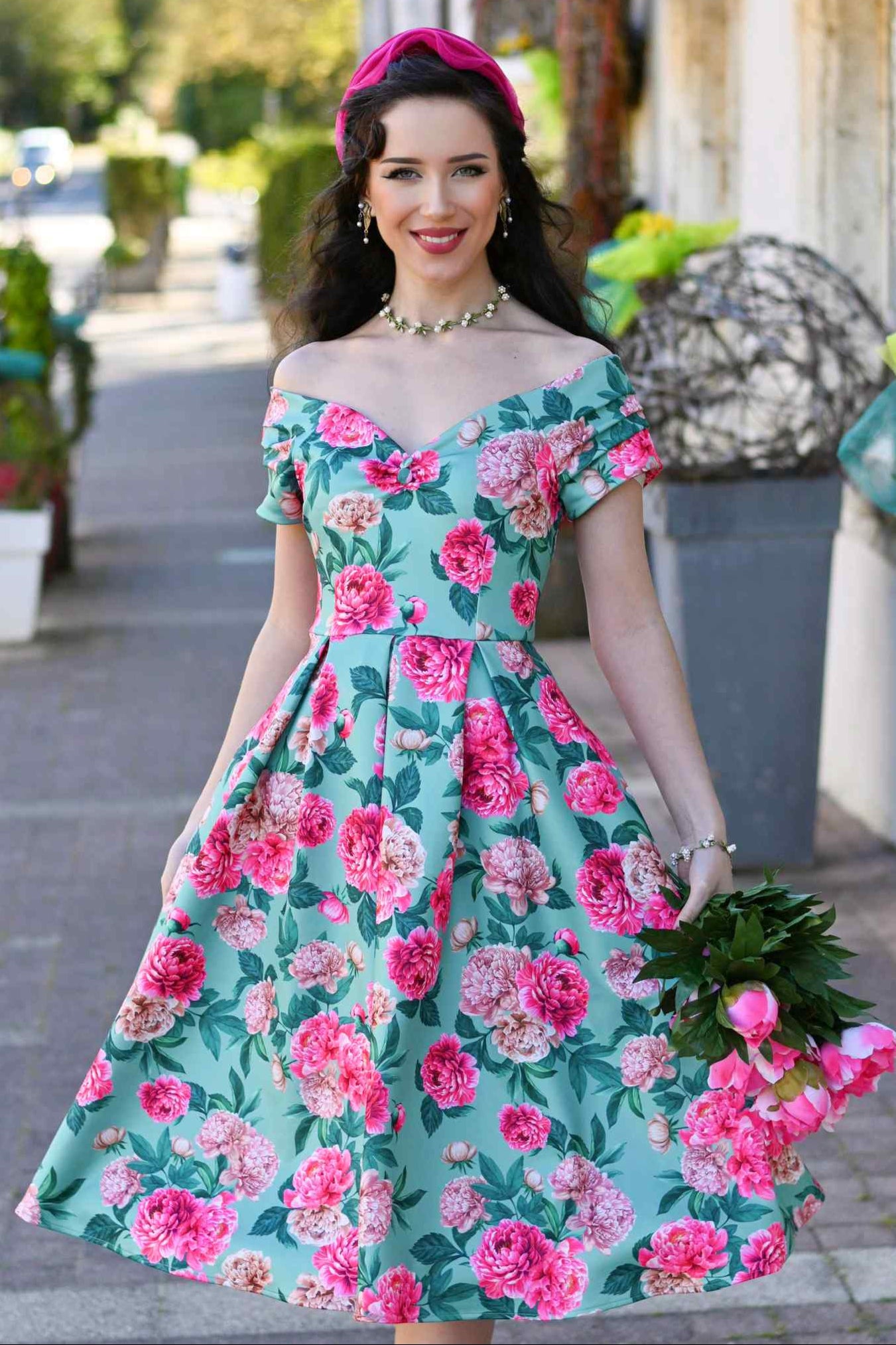 Model wearing a Pink Peony Off Shoulder Dress In Mint Green