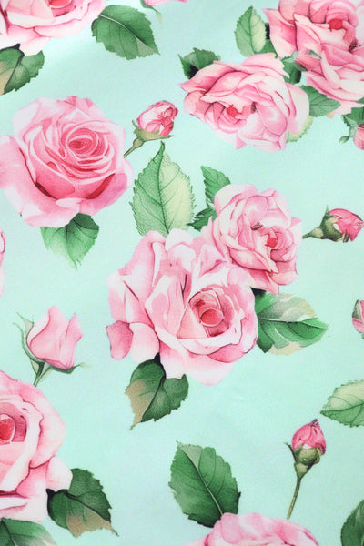 Close up view of Pink Rose Midi Dress In Baby Blue