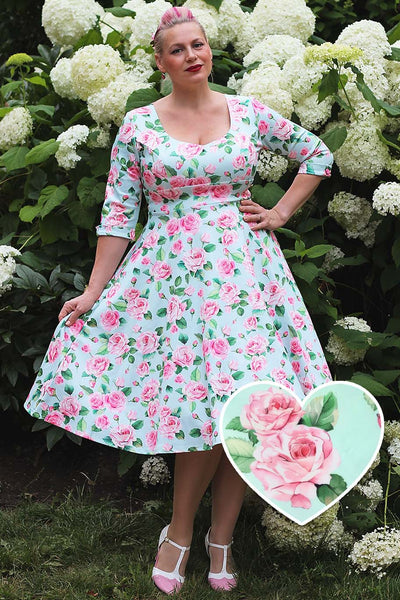 A lady wearing a Pink Rose Midi Dress In Baby Blue
