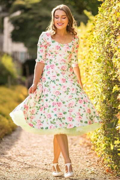 A girl wearing a Scarlette Pink Rose Midi Dress In Baby Blue