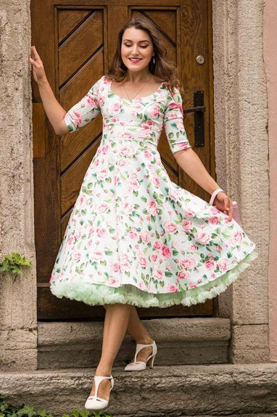 A lovely girl wearing a Scarlette Pink Rose Midi Dress In Baby Blue