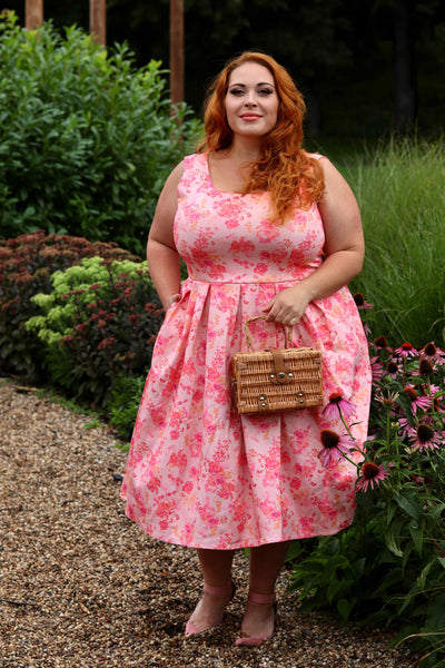 A lovely model wearing an Amanda Pink Shadow Floral Swing Dress