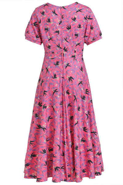 pink short sleeved tea dress, with swallow bird print, back view