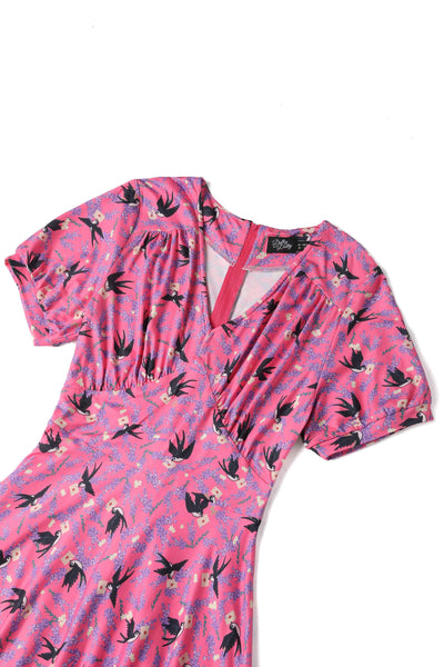 pink short sleeved tea dress, with swallow bird print, close view