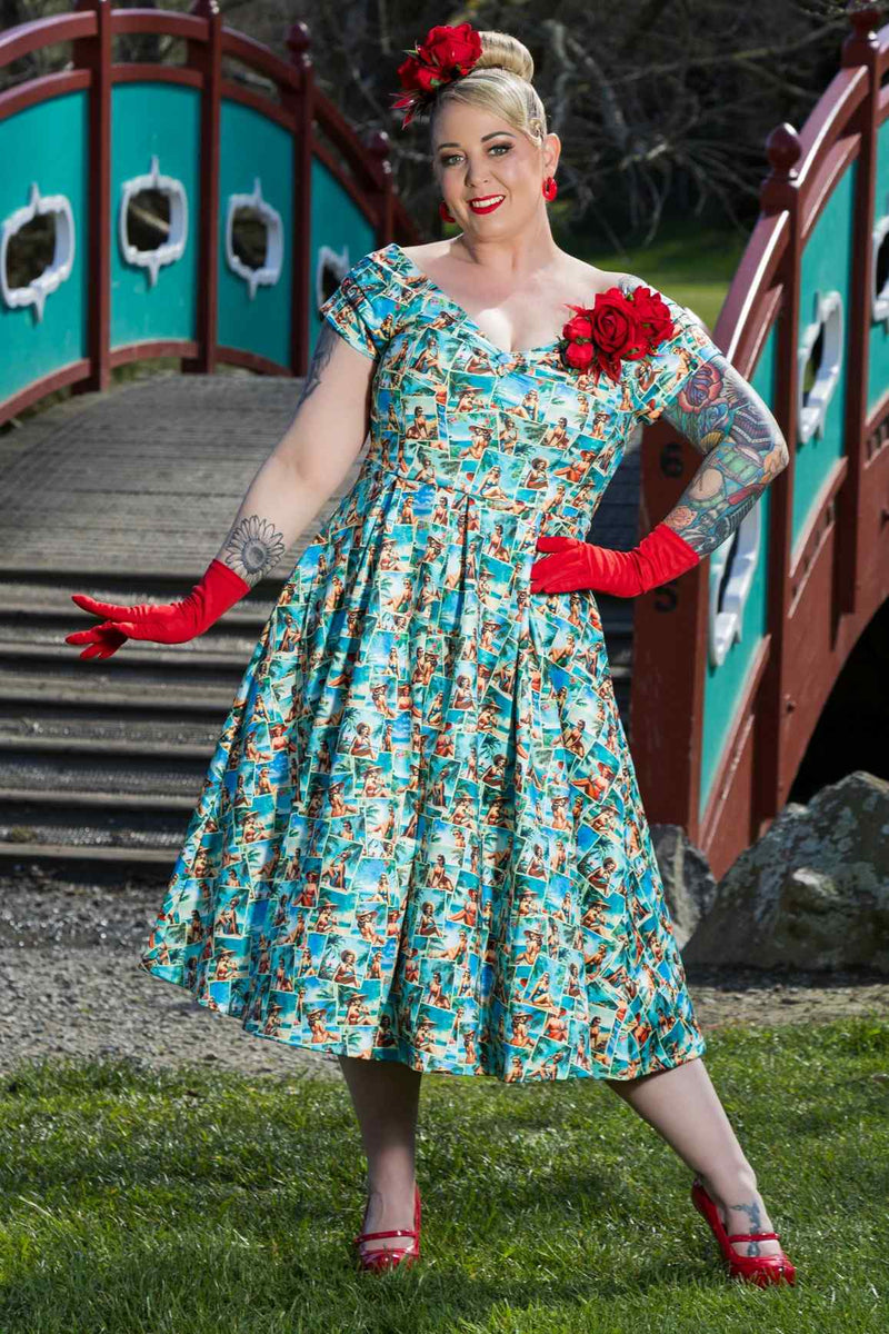 A model wearing a Lily Pinup Postcard Off Shoulder Dress