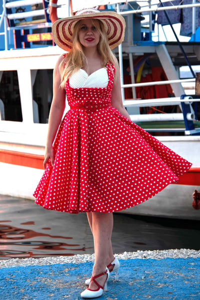 A model wearing a Pleated 50s Style Swing Dress Red Polka Dots