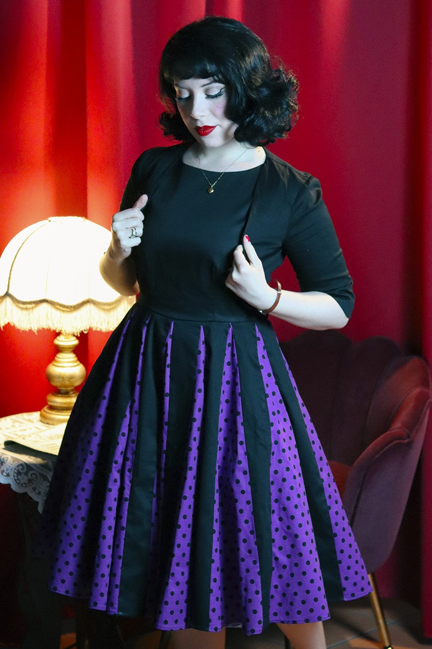 A model wearing in Judith Pleated Black/Purple Dress With Polka Dots