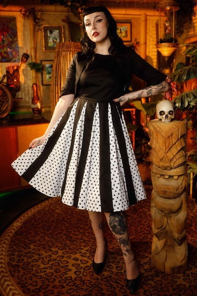 A lady wearing a Pleated Black Dress With White Polka Dots