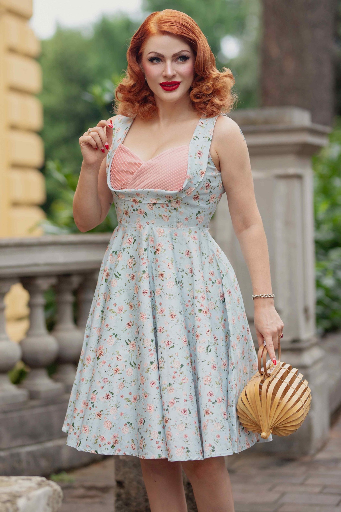 A model wearing a Pleated Bust Dress in Baby Blue/Pink Floral Print