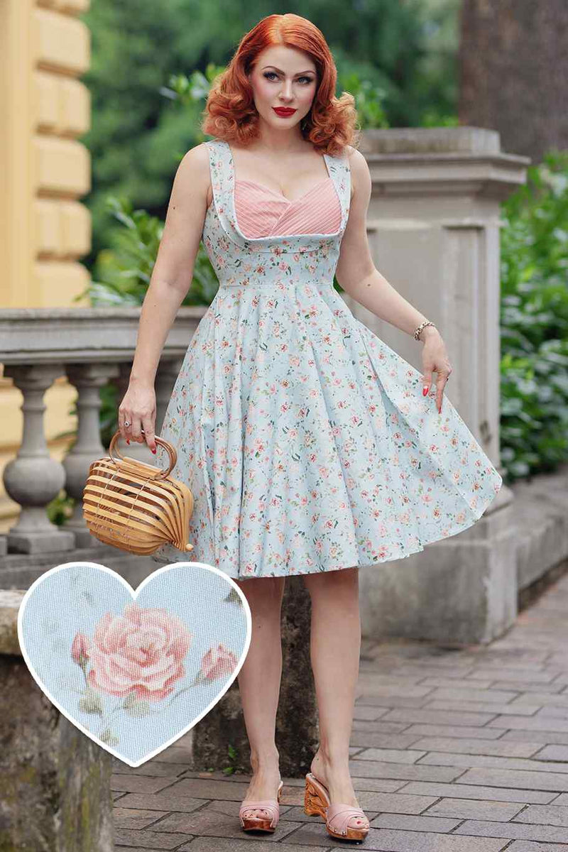 A model wearing a Pleated Bust Dress in Baby Blue/Pink Floral Print