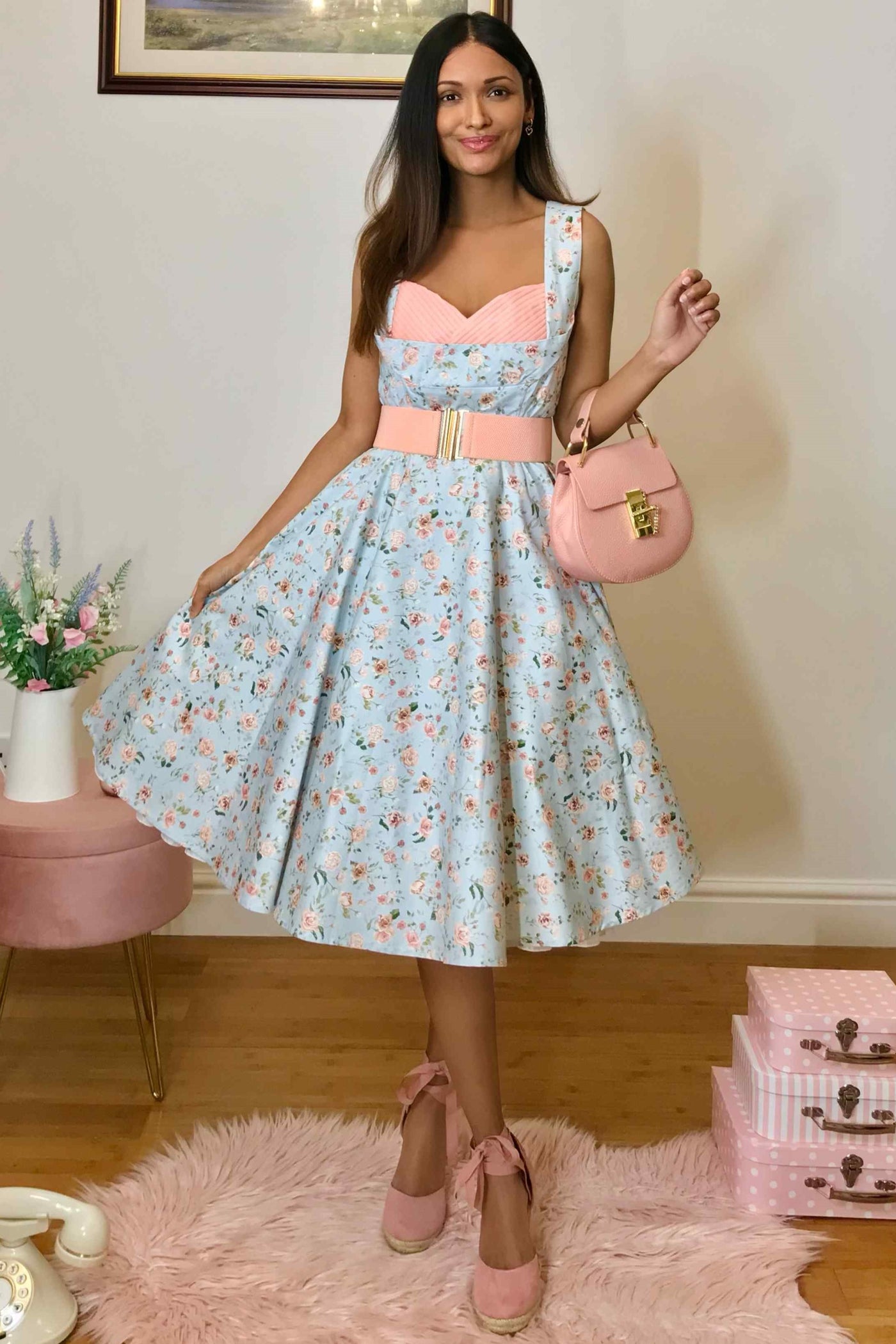 A model wearing Pleated Bust Dress in Baby Blue/Pink Floral Print
