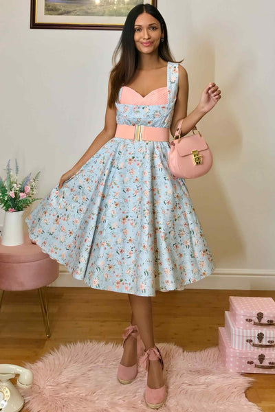 A model wearing Pleated Bust Dress in Baby Blue/Pink Floral Print