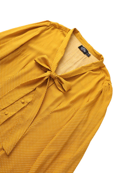 Close up view the bow tie of Margaret Polka Dot Long Sleeved Blouse In Yellow