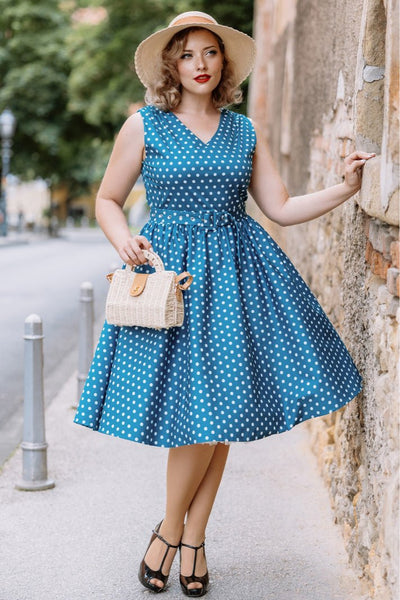 A model wearing a Polka Dot Rockabilly Swing Dress in Teal