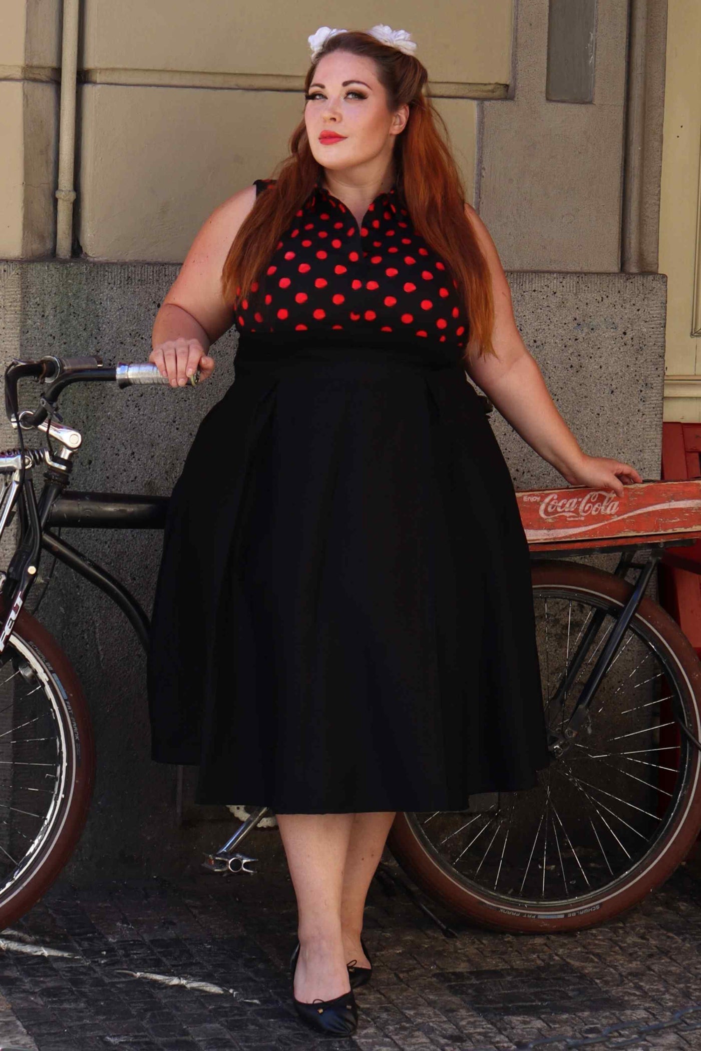 A lady wearing a Polka Dot Shirt Dress in Black and Red