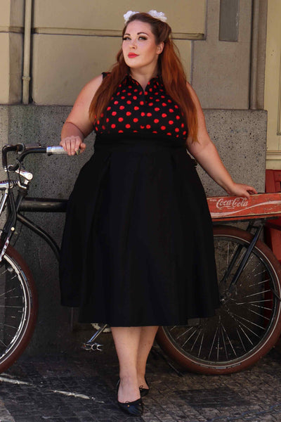 A lady wearing a Polka Dot Shirt Dress in Black and Red