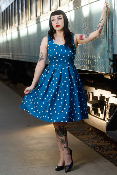 A model wearing Polka Dot Swing Dress Peacock Blue & White