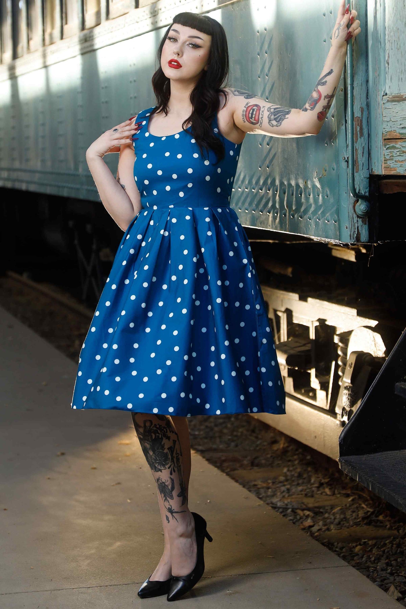 Front view of model wearing Polka Dot Swing Dress Peacock Blue & White