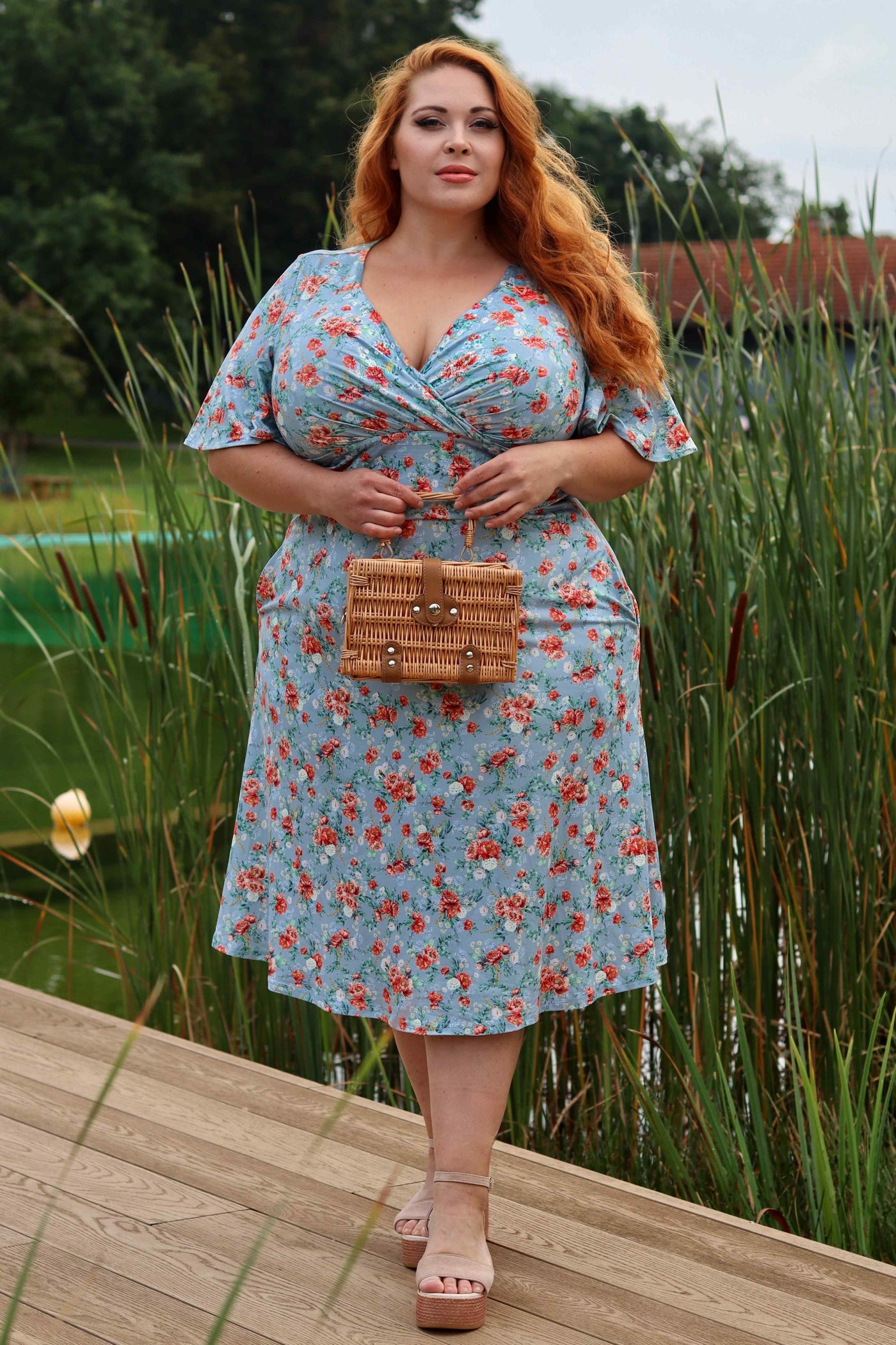 A lady wearing a Poppy Flowers Day Dress in Baby Blue