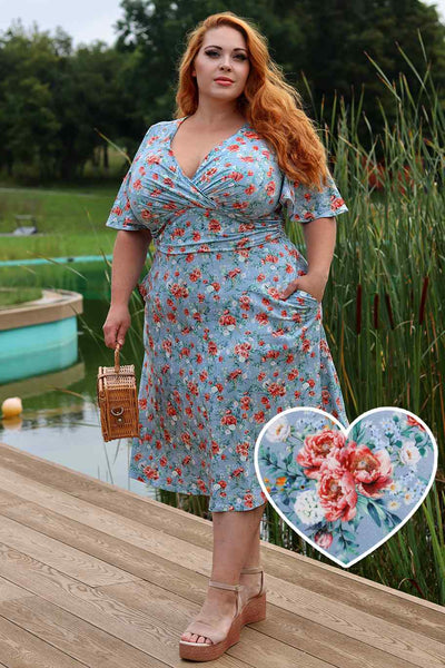 A lady wearing a Donna Baby Blue Poppy Day Dress