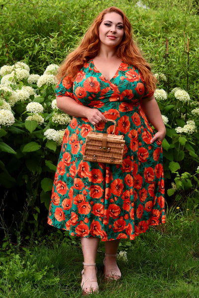 A lady wearing a Julia Poppy Midi Dress In Teal