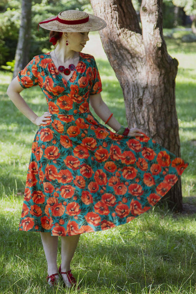 A woman wearing a Julia Poppy Midi Dress In Teal