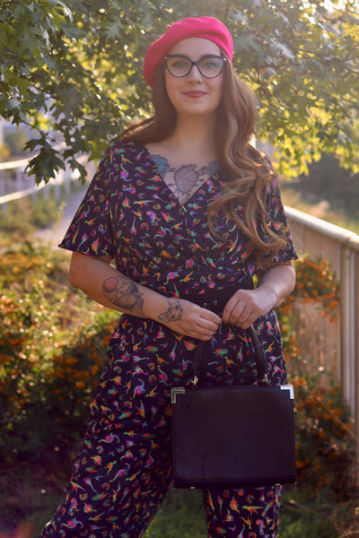 A model wearing a Dinosaurs & Rainbow Black Jumpsuit
