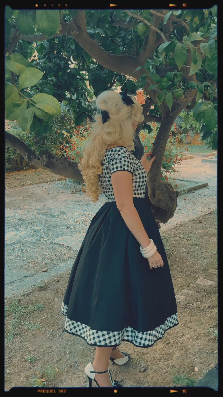 A video of Ms. @miss_ladynoir wearing our  Lily Off Shoulder Black/White Gingham Swing Dress.