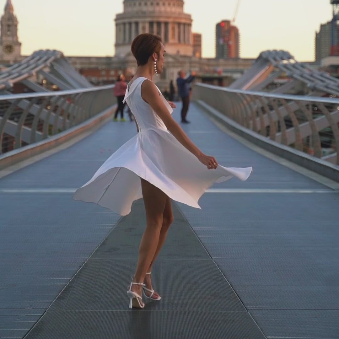 Video of a model, twirling and wearing our Grace White Jive Swing Dress for Vintage Wedding.