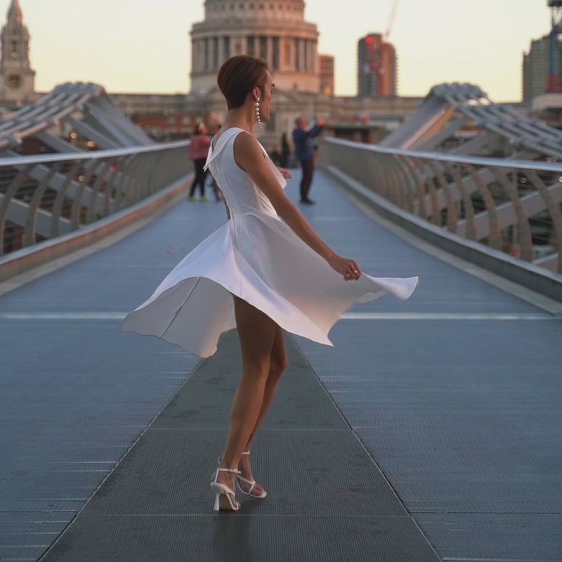 Video of a model, twirling and wearing our Grace White Jive Swing Dress for Vintage Wedding.