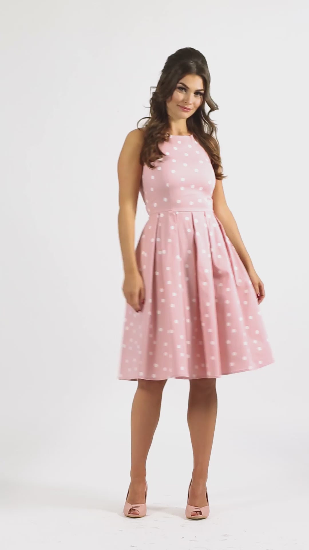 Video of a model wearing our Annie Retro Polka Dot Dress in Pale Pink & White.