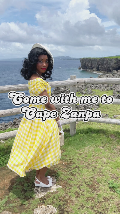 Video of a woman in a Lighthouse wearing a Yellow and White Gingham Dress.