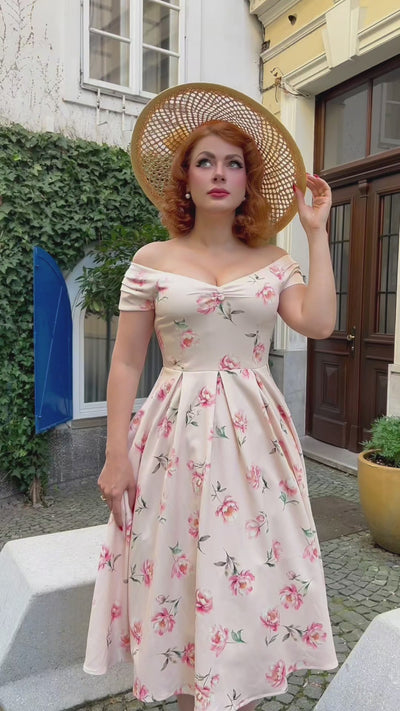 A view of a model wearing Cream & Pink Peony Off Shoulder Dress