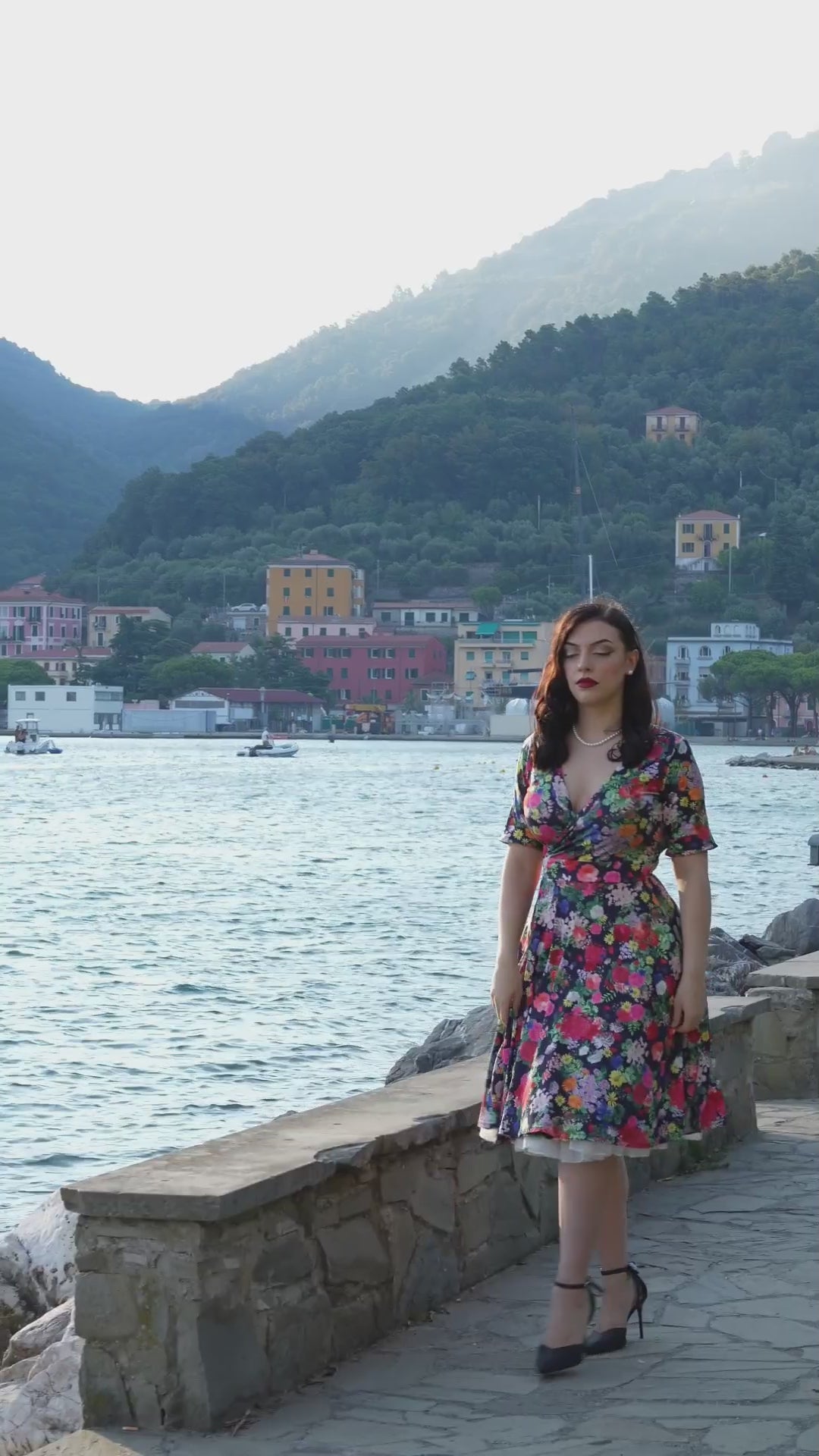 Video of a model wearing our Matilda Navy Blue Midnight Garden Floral Wrap Dress.