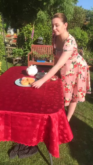 A video of emi.haines wearing our Claudia 50s Style Vintage Inspired Pink Strawberry Dress on an Afternoon Tea Party. 