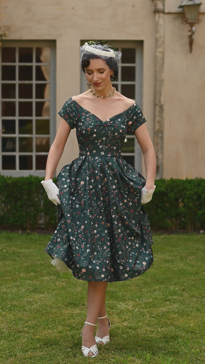 Video of a women wearing a Green Ditsy Floral Off Shoulder Flared Dress