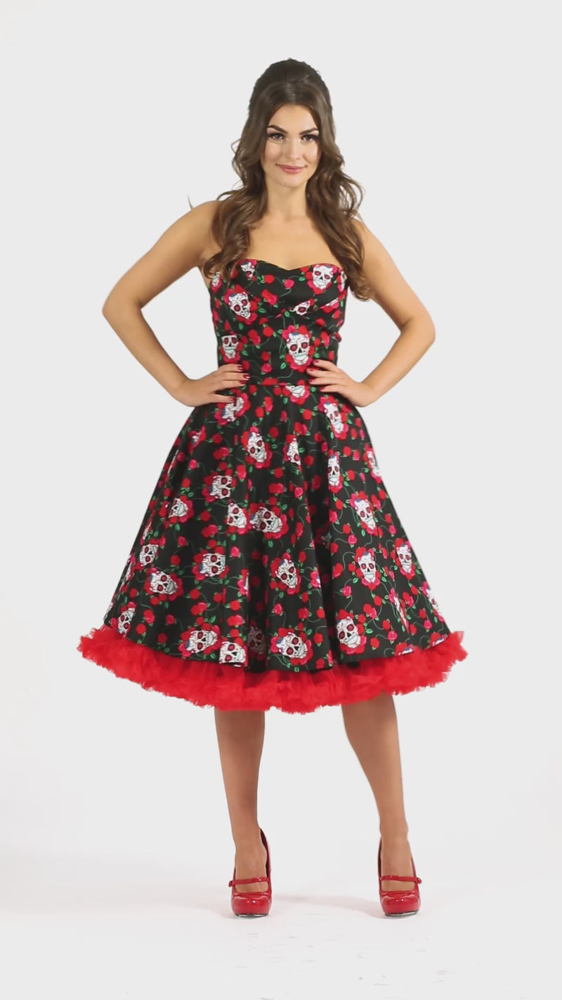 Video of a model twirling and wearing a Black Rockabilly Dress with Skulls and Roses print.