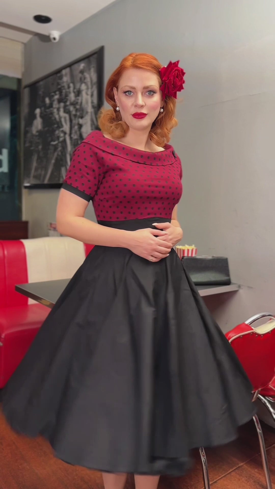 A model wearing a Full Circle Swing Dress in Burgundy Polka-Black